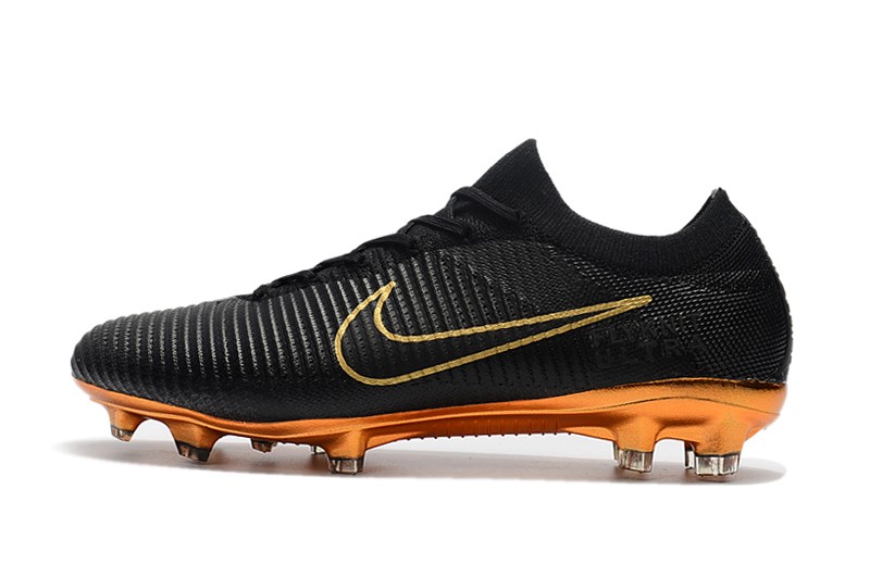 gold and black nike boots