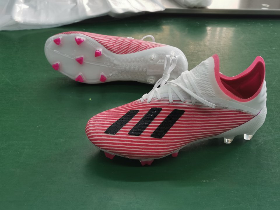 pink and white football cleats